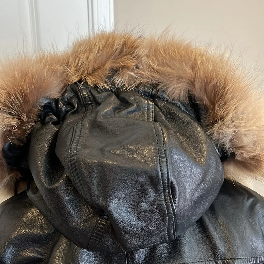 Vintage men’s SZ sm black leather coat w/fur trim hood.  Hits below the hips.